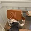 Brown leather camera bag with 3D embossed letters and patterned wide woven strap - Brown