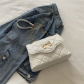 Elegant white quilted crossbody bag with golden bow clasp and stylish chain strap - White
