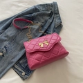 Pink quilted crossbody bag with golden bow and chain strap on blue denim - Rose Pink