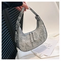 Detail of silver crescent bag featuring unique crinkled paper texture and double zippers - Silver