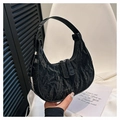 Close-up of black crescent bag featuring crinkled texture and silver metal zippers - Black