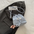 Light blue drawstring bucket bag with silver metal bow and pleated texture - Blue