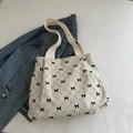 Sac fourre-tout en velours beige à nœuds noirs avec bandoulière en toile, vue de haut - Blanc Cassé