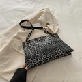 Leopard print shoulder bag with black chunky chain and golden hardware accents - Black
