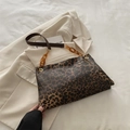 Leopard print shoulder bag with amber acrylic chain on a cream blazer - Brown