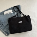 Large black corduroy tote bag for women with minimalist shoulder strap and fashion label - Black