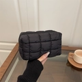 Black quilted puffer cosmetic bag with zipper closure and textured square pattern - Black