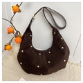 Detailed close-up of dark brown suede crescent bag with gold sphere studs and hardware - Brown