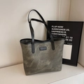 Minimalist grey-green tote bag with black straps and subtle marble texture design - Dark Brown