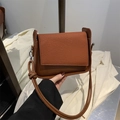 Minimalist caramel brown crossbody bag with woven texture flap and smooth finish - Brown