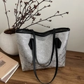 Silver metallic textured tote bag with black shoulder straps in a minimalist setting - Silver