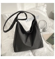 Classic black and white checkered tote bag displayed in a cozy lifestyle setting - Black