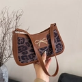 Brown leather leopard print underarm bag with a golden bow buckle in hand - Leopard Print Black