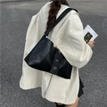 Minimalist black faux leather underarm bag with gold metal ring detail shown on model - Black