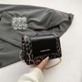 Fashionable leopard print and black leather crossbody bag with golden chain strap - Brown