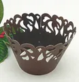 Macro shot of laser-cut chocolate paper cupcake wrappers with heart pattern - 5cm / Coffee