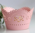 Detail of pink laser-cut cupcake wrapper featuring intricate white rose lace patterns - Pink