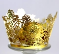 Close-up of golden laser-cut cupcake wrapper with floral pattern and chocolate decoration - Reflective Gold