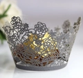 Macro shot of laser-cut rose cupcake wrapper in silver grey with golden chocolate ball - Silver Charcoal