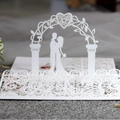 White laser cut wedding invitation card featuring elegant 3D lace design and couple silhouette - White