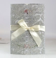 Detail of laser-cut wedding invitation with silver glitter lace and white satin bow - Glitter Silver