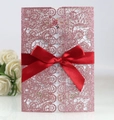Detailed laser-cut pink glitter wedding invitation shell with a red satin bow and insert - Glitter Pink