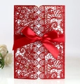 Detail of red glitter laser-cut invitation card with floral patterns and a satin ribbon bow - Glitter Red