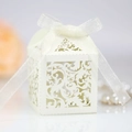 Elegant cream laser-cut wedding favor box with lace patterns and silk ribbon bow - Ivory