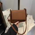 Caramel brown minimalist crossbody bag featuring a woven flap and elegant side knot detail - Brown