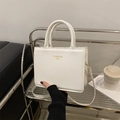Chic white square tote bag with gold lettering and adjustable strap for daily commute - White