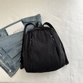 Minimalist black nylon backpack with multiple zipper pockets for daily travel and school - Black