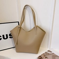 Minimalist beige pebble leather tote bag with unique wavy top edge and adjustable straps - Khaki