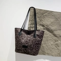Fashionable grey leopard print tote bag with black straps on a textured stone base - Large Leopard Grey