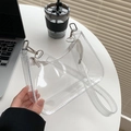 Clear PVC jelly shoulder bag with white zipper shown in a casual lifestyle setting - Clear