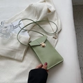 Chic light green mini phone bag in PU leather with gold clasp on white blazer background - Green