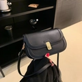 Minimalist matte black crossbody bag with gold buckle and slim strap for women - Black