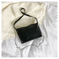Minimalist black leather shoulder bag with silver metal chain on white cloth - Black