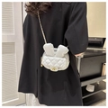 Dettaglio della mini borsa trapuntata con orecchie di coniglio indossata da una modella - Bianco