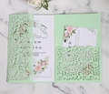Macro view of mint green laser-cut wedding invitation set with floral lace detailing - Fruit Green
