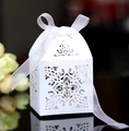 Detail of laser-cut cross and floral hollow design on white wedding favor box - White