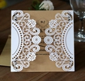 Detailed view of laser-cut wedding invitation with kraft paper inserts on a wooden table - Vintage Hollow Set Style (HK-17)