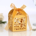 Exquisite gold laser-cut镂空 candy gift box with elegant ribbon for luxury wedding favors - Gold