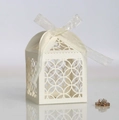 Elegant white laser-cut favor box with ribbon and intricate floral hollow design - Ivory