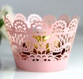 Close-up of pink laser-cut lace cupcake wrapper with intricate floral petal patterns - Pink