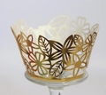 Detail of laser-cut golden cupcake liners with intricate floral lace and metallic finish - Reflective Gold