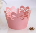 Laser cut pearlescent pink cupcake wrappers with hollow bow design for party decor - Pink