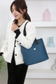 Navy blue oxford fabric tote bag shown on model for stylish daily use and commuting - Blue