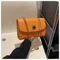 Fashionable orange square crossbody bag with gold chain strap and clover clasp - Orange