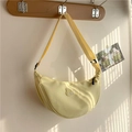 Detail of light yellow crescent crossbody bag with brand patch and adjustable wide strap - Yellow