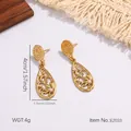 Macro shot of gold teardrop earrings with hollow patterns and white pearl inlay detail - Vintage Hollow Waterdrop Style (E2033)